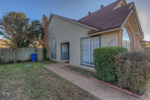 rear view of property with a yard