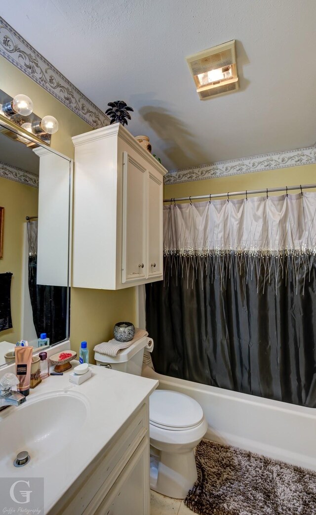 full bathroom featuring tile patterned floors, vanity, toilet, and shower / bath combo