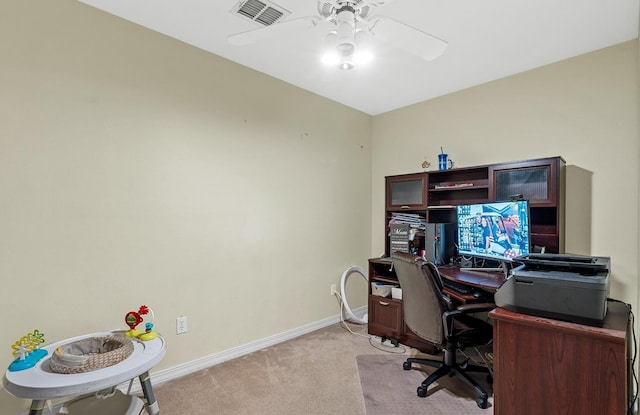 carpeted office featuring ceiling fan