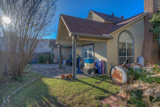 back of property featuring a lawn, a patio area, and french doors