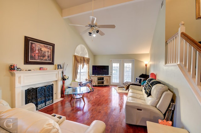 living room with hardwood / wood-style flooring, ceiling fan, beamed ceiling, and high vaulted ceiling