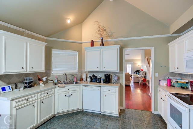 kitchen featuring sink, backsplash, white cabinets, and white appliances