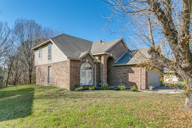 view of front of house featuring a garage and a front lawn