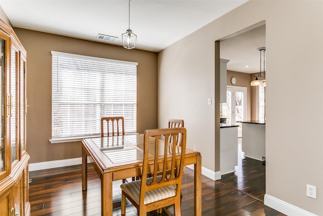 dining area with a healthy amount of sunlight and dark wood-type flooring