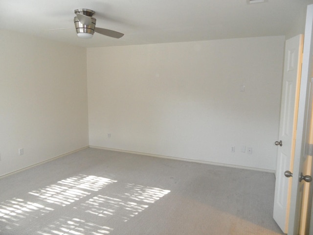 unfurnished room featuring light carpet and ceiling fan