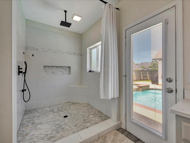 bathroom with a tile shower