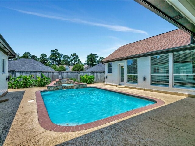 view of pool featuring a fenced in pool, a fenced backyard, a patio, and a hot tub