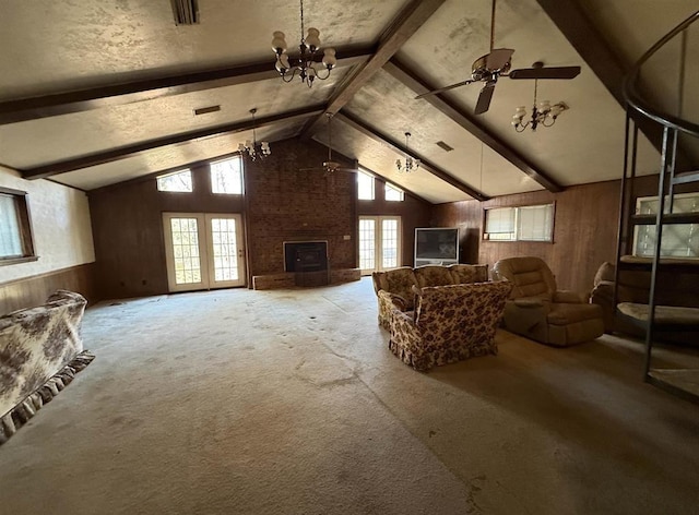 additional living space with carpet, ceiling fan with notable chandelier, wood walls, and lofted ceiling with beams