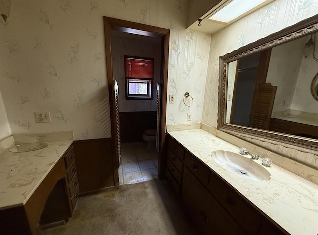 bathroom featuring vanity and toilet