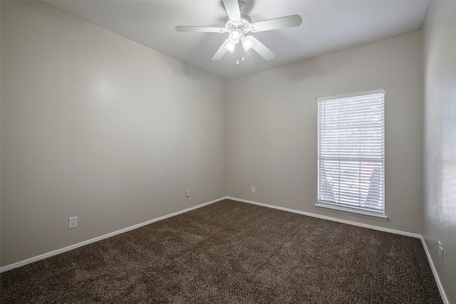 unfurnished room with ceiling fan and carpet