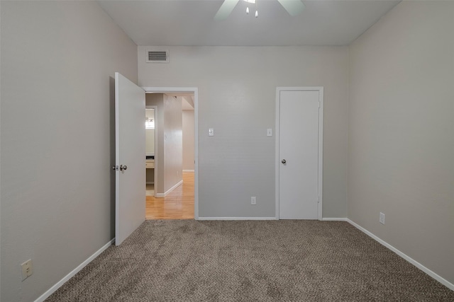 unfurnished bedroom featuring carpet and ceiling fan