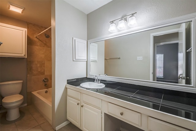 full bathroom with tile patterned flooring, vanity, toilet, and tiled shower / bath combo