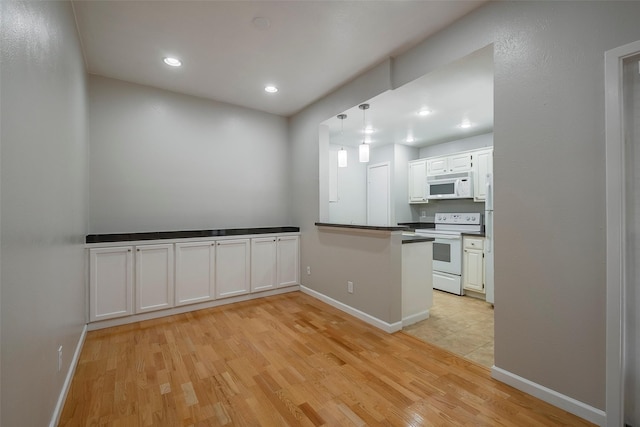 kitchen featuring white cabinetry, white appliances, and light hardwood / wood-style flooring