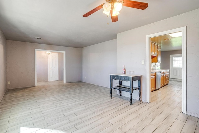 empty room featuring ceiling fan and light hardwood / wood-style flooring