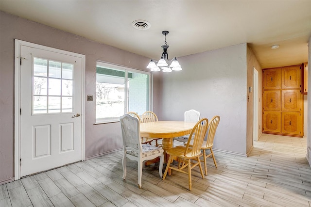 dining space with an inviting chandelier