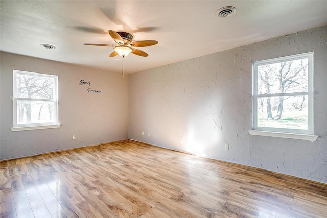 empty room with ceiling fan and light wood-type flooring