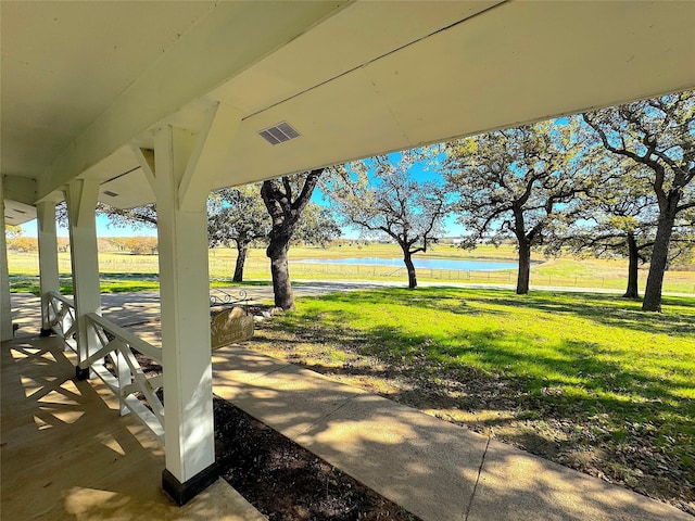 exterior space featuring a water view and a yard