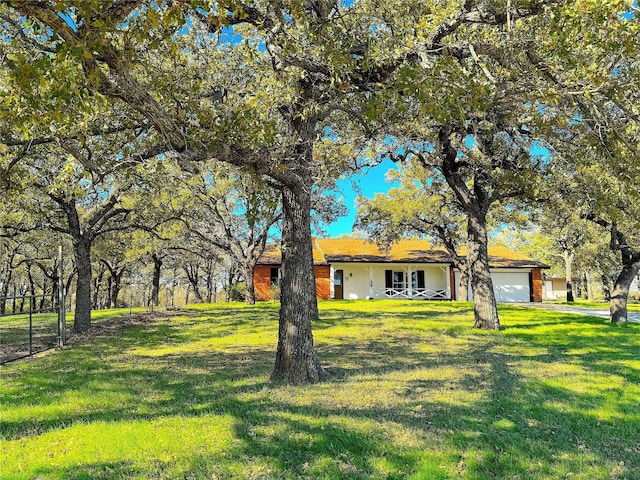 ranch-style house with a garage and a front yard