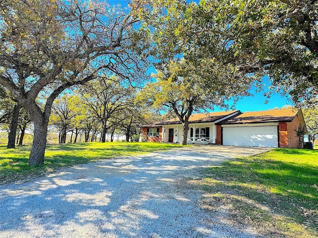 ranch-style home featuring a front yard and a garage