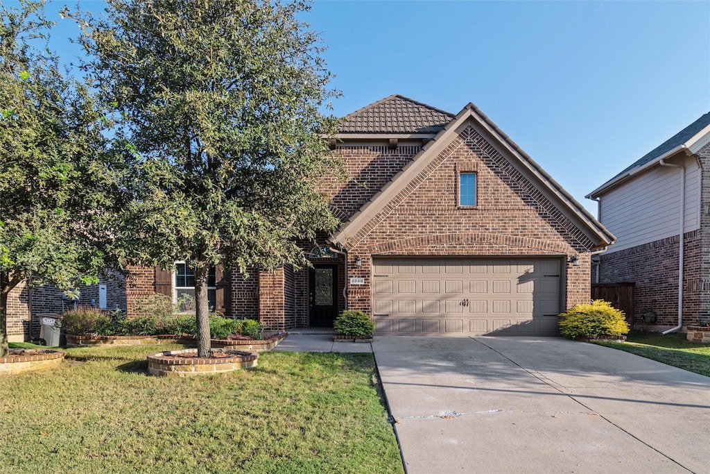 view of front property with a garage and a front lawn