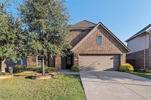 front of property featuring a front lawn and a garage