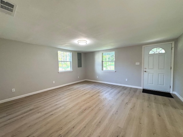 entrance foyer with electric panel and light wood-type flooring