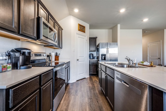 kitchen with dark brown cabinetry, sink, stainless steel appliances, and dark hardwood / wood-style floors