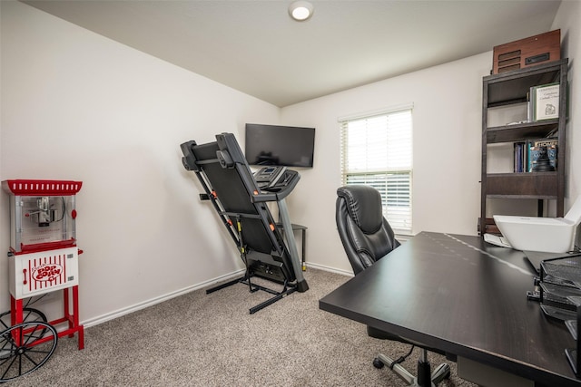 home office with carpet flooring and vaulted ceiling