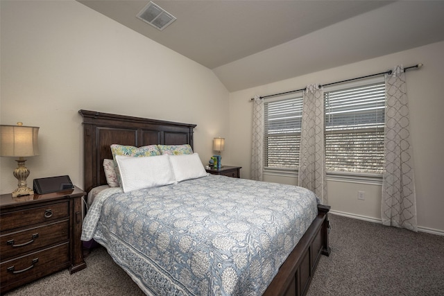 bedroom with lofted ceiling and dark colored carpet