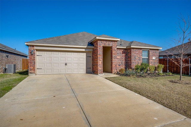 view of front facade with central AC unit, a garage, and a front lawn