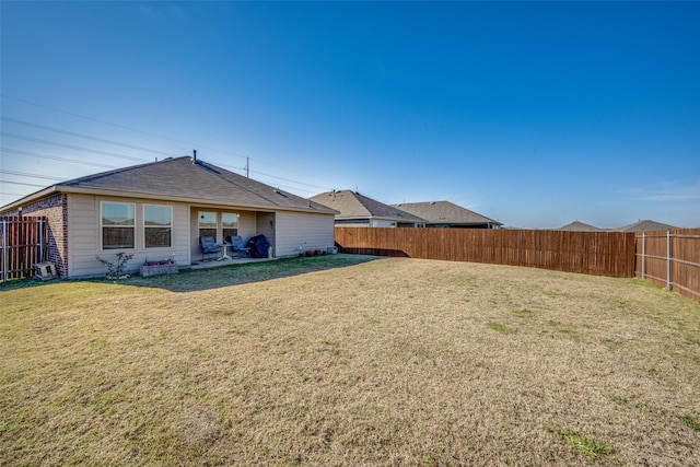 rear view of house featuring a lawn