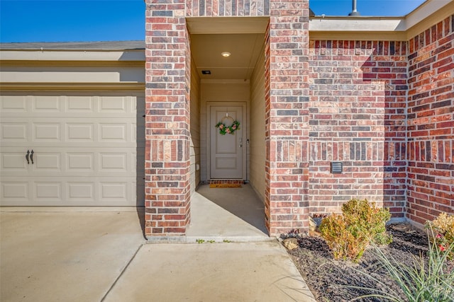 view of exterior entry with a garage