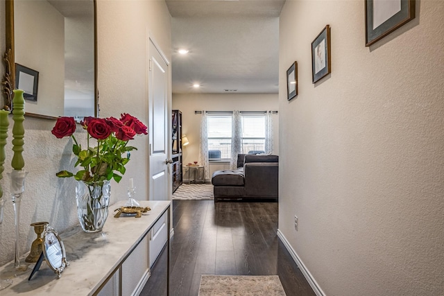 hallway featuring dark hardwood / wood-style floors