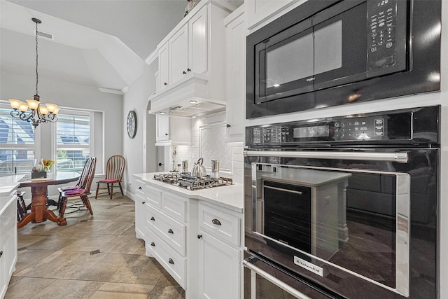 kitchen featuring white cabinetry, decorative backsplash, black appliances, and an inviting chandelier