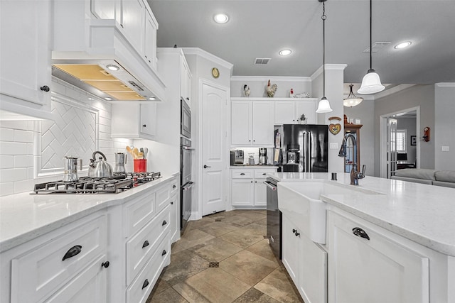 kitchen featuring appliances with stainless steel finishes, ventilation hood, crown molding, pendant lighting, and white cabinetry