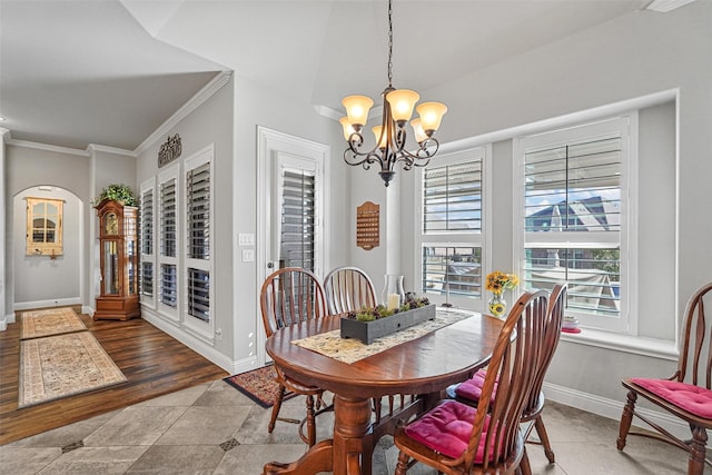 dining area featuring crown molding and a chandelier