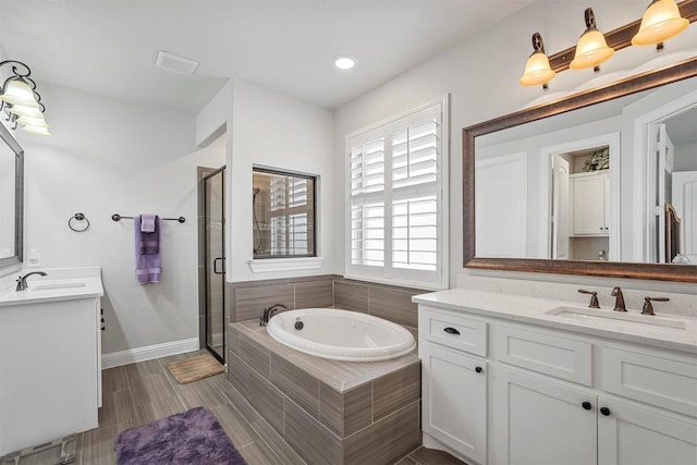 bathroom with independent shower and bath and vanity