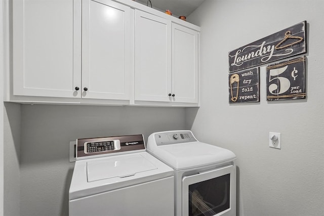 laundry room featuring cabinets and separate washer and dryer