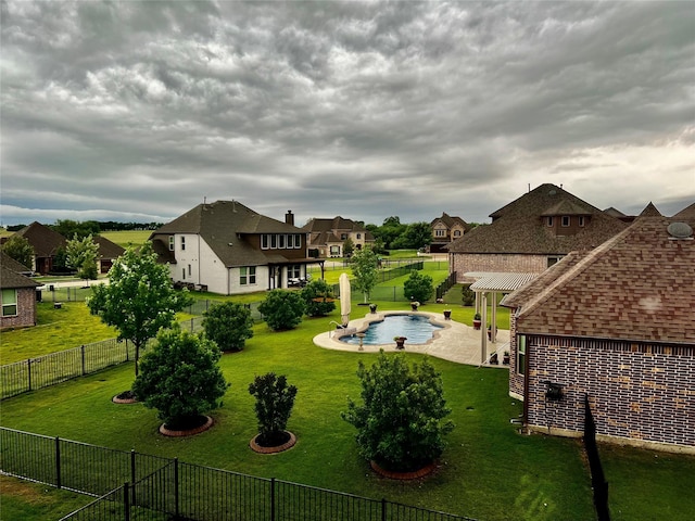 view of yard with a fenced in pool and a pergola