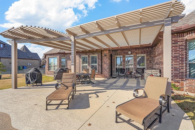 view of patio with a pergola and area for grilling