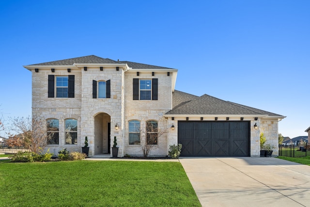 view of front of house featuring a garage and a front lawn