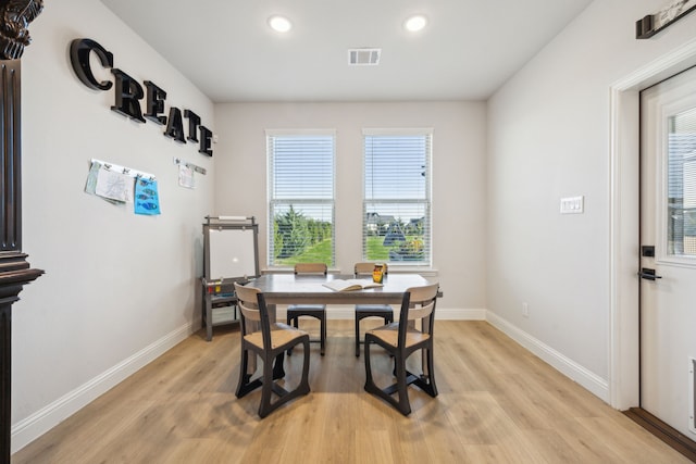 dining space with light hardwood / wood-style floors