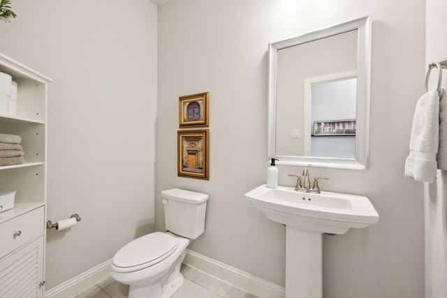 bathroom with tile patterned flooring, sink, and toilet