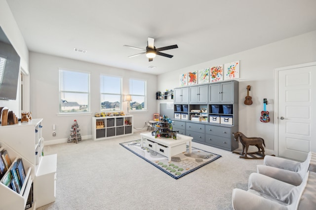 living room with ceiling fan and carpet flooring