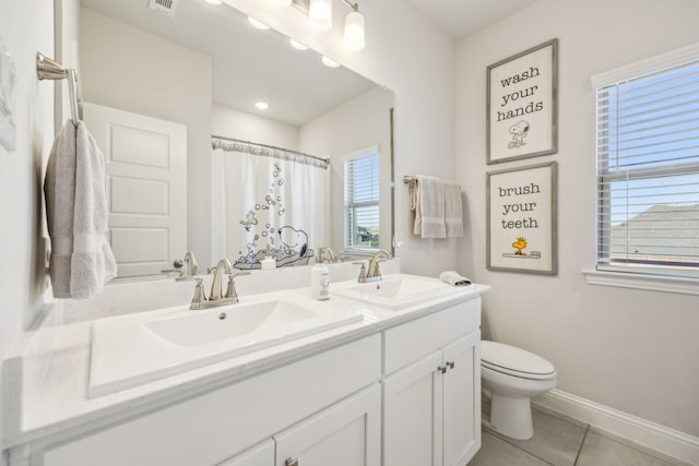 bathroom featuring walk in shower, tile patterned floors, vanity, and toilet