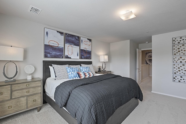 carpeted bedroom featuring a textured ceiling