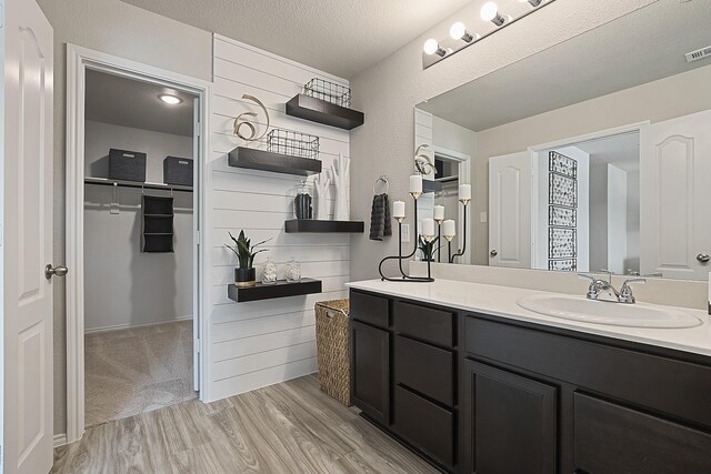 bathroom featuring vanity, a textured ceiling, and hardwood / wood-style flooring