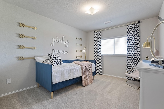 carpeted bedroom with a textured ceiling