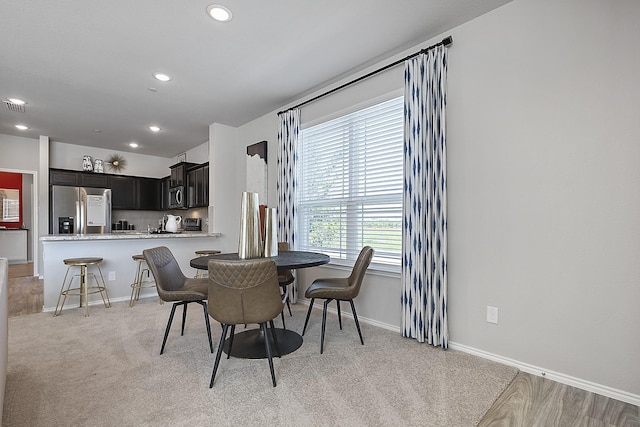 dining space with light colored carpet