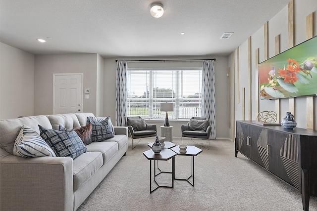 carpeted living room with a textured ceiling